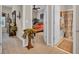 Hallway view leading to a bathroom and bedroom with carpet floors, light beige walls, and decorative wall art at 327 Trestle Way, Conway, SC 29526