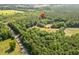 A scenic aerial view highlighting a parcel of land, showcasing a blend of woods and fields at 3534 Nichols Hwy., Galivants Ferry, SC 29544