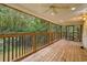Relaxing screened back porch with wooden floors and ceiling fans offers an outdoor living space at 3534 Nichols Hwy., Galivants Ferry, SC 29544