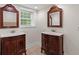 Elegant bathroom with double vanity, stylish mirrors, and a window for natural light at 3534 Nichols Hwy., Galivants Ferry, SC 29544