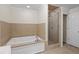 Bathroom featuring a soaking tub, a glass-enclosed shower, and tiled walls at 3534 Nichols Hwy., Galivants Ferry, SC 29544