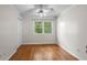 Cozy bedroom showcasing hardwood floors, a ceiling fan, closet, and a bright window at 3534 Nichols Hwy., Galivants Ferry, SC 29544