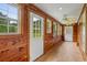 Hallway with wood paneling, tile floors, and lots of natural light at 3534 Nichols Hwy., Galivants Ferry, SC 29544