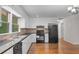 Kitchen with granite counters, black appliances, and hardwood floors at 3534 Nichols Hwy., Galivants Ferry, SC 29544