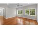 Living room featuring hardwood floors, ceiling fan, multiple windows, and neutral paint at 3534 Nichols Hwy., Galivants Ferry, SC 29544