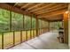 Covered screened-in patio with natural wood ceiling and view of lush backyard at 3534 Nichols Hwy., Galivants Ferry, SC 29544