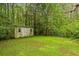 Charming shed on a verdant lot, complete with fencing and surrounded by mature trees at 3534 Nichols Hwy., Galivants Ferry, SC 29544