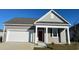 Charming single-story home with gray siding, white trim, and a red front door, enhancing curb appeal at 3550 Ashridge Way, Conway, SC 29526