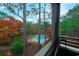 Balcony view overlooking a sparkling pool, mature trees, and the surrounding property at 415 Ocean Creek Dr. # 2373, Myrtle Beach, SC 29572