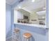 Cozy kitchen bar with white cabinets, granite counters, and seating for two at 415 Ocean Creek Dr. # 2373, Myrtle Beach, SC 29572