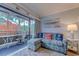 Living room featuring a tropical-themed sectional, cozy seating, and access to a screened balcony at 415 Ocean Creek Dr. # 2373, Myrtle Beach, SC 29572
