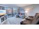 Comfortable living room featuring a cozy sectional sofa, plush reclining chairs, and access to the balcony at 415 Ocean Creek Dr. # 2373, Myrtle Beach, SC 29572