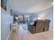 Bright living room with a comfortable recliner, sectional sofa, and sliding doors to the balcony at 415 Ocean Creek Dr. # 2373, Myrtle Beach, SC 29572