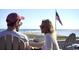 Relaxing ocean view with a couple enjoying the coastal scenery and the American flag waving in the background at 415 Ocean Creek Dr. # 2373, Myrtle Beach, SC 29572
