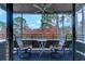 Cozy screened porch with chairs and a table, perfect for enjoying the view and fresh air at 415 Ocean Creek Dr. # 2373, Myrtle Beach, SC 29572