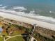 A scenic aerial view of the beach, dunes, and a wooden boardwalk at 417 S Dunes Dr., Pawleys Island, SC 29585