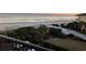 Balcony view of the sandy beach with white boardwalk and ocean views at sunset at 417 S Dunes Dr., Pawleys Island, SC 29585