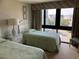 Bedroom showcasing two twin beds, side table, lamp, and a large window view at 417 S Dunes Dr., Pawleys Island, SC 29585