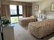 Comfortable bedroom featuring two twin beds, side tables, and a view of the landscape at 417 S Dunes Dr., Pawleys Island, SC 29585