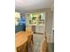 Open-concept dining area featuring a wet bar with cabinets, sink, and beverage refrigerator at 417 S Dunes Dr., Pawleys Island, SC 29585