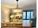 Dining room and living room with modern lighting and access to a balcony at 417 S Dunes Dr., Pawleys Island, SC 29585