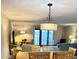 Dining room and living room with modern lighting and access to balcony at 417 S Dunes Dr., Pawleys Island, SC 29585