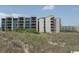 Exterior shot of the condo buildings showcasing multiple balconies and views at 417 S Dunes Dr., Pawleys Island, SC 29585