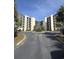 Beautiful exterior view of the condo complex featuring tropical landscaping and a roundabout driveway at 417 S Dunes Dr., Pawleys Island, SC 29585