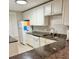 Bright kitchen with white cabinets, granite countertops, and stainless steel appliances at 417 S Dunes Dr., Pawleys Island, SC 29585