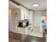 Kitchen featuring white cabinets, granite countertops, and modern appliances at 417 S Dunes Dr., Pawleys Island, SC 29585