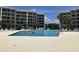 Outdoor swimming pool surrounded by lounge chairs and condo buildings at 417 S Dunes Dr., Pawleys Island, SC 29585