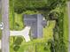 Expansive aerial view of a home featuring a dark roof, concrete driveway, and lush landscaping at 4197 Friendfield Trace, Little River, SC 29566
