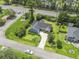 Bright aerial view of a home with blue siding, complemented by lush landscaping and a winding driveway at 4197 Friendfield Trace, Little River, SC 29566