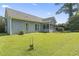 Backyard featuring green grass and partial view of home at 4197 Friendfield Trace, Little River, SC 29566