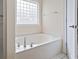Bathtub with a glass block window at 4197 Friendfield Trace, Little River, SC 29566