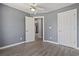 Bedroom with modern gray walls, white doors, and light wood-look flooring at 4197 Friendfield Trace, Little River, SC 29566