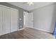 Bedroom featuring modern wood-look flooring, neutral walls, and closet at 4197 Friendfield Trace, Little River, SC 29566