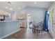 Dining room showcasing wood floors, French doors, a dining table, and an opening to the kitchen area at 4197 Friendfield Trace, Little River, SC 29566