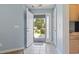 Bright foyer with tiled floor, blue walls, and the front door open showcasing the front yard at 4197 Friendfield Trace, Little River, SC 29566