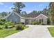 Charming single-story home with a well-manicured lawn, long driveway and a mix of brick and siding accents at 4197 Friendfield Trace, Little River, SC 29566