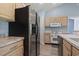 Kitchen with stainless steel refrigerator, light wood cabinets, and white appliances at 4197 Friendfield Trace, Little River, SC 29566