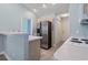 The well-lit kitchen offers a bar area and stainless steel refrigerator at 4197 Friendfield Trace, Little River, SC 29566