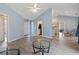 Open concept living room with wood floors and blue walls that leads to the entry, dining area and kitchen at 4197 Friendfield Trace, Little River, SC 29566