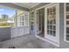 Screened in porch with white trim and view to backyard at 4197 Friendfield Trace, Little River, SC 29566