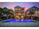 Expansive backyard with a sparkling pool, lounge chairs, covered patios, and stunning sunset views, perfect for outdoor entertaining at 496 West Palm Dr., Myrtle Beach, SC 29579