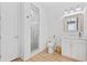 Modern bathroom with white shiplap walls, tiled glass shower, white vanity, and wood-look tile floor at 496 West Palm Dr., Myrtle Beach, SC 29579