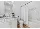 Clean bathroom featuring marble tile accent wall, shower-tub combo and modern vanity at 496 West Palm Dr., Myrtle Beach, SC 29579