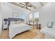 Bright bedroom featuring wood beams, ceiling fan, lots of natural light, plush carpet, and stylish furnishings at 496 West Palm Dr., Myrtle Beach, SC 29579