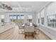 Bright dining room with hardwood floors, coffered ceilings, modern furniture, and large windows that provides scenic views at 496 West Palm Dr., Myrtle Beach, SC 29579