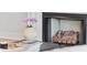 Close-up of the fireplace with decorative logs and elegant floral arrangement at 496 West Palm Dr., Myrtle Beach, SC 29579
